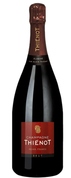 En glasflaska med Thiénot Brut, ett champagne från Champagne i Frankrike