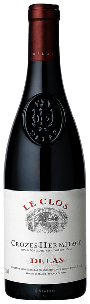 En glasflaska med Delas Crozes-Hermitage Le Clos 2020, ett rött vin från Rhonedalen i Frankrike