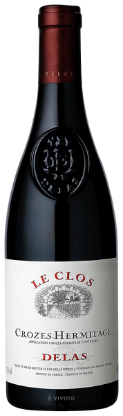 En glasflaska med Delas Crozes-Hermitage Le Clos 2020, ett rött vin från Rhonedalen i Frankrike