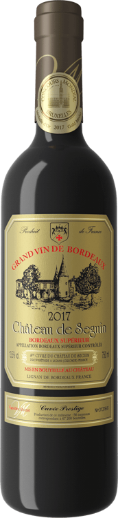 En glasflaska med Chateau De Seguin Cuvée Prestige, ett rött vin från Bordeaux i Frankrike