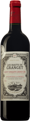 En glasflaska med Les Hauts de Granget, ett rött vin från Bordeaux i Frankrike