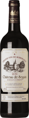 En lättare glasflaska med Château de Seguin, ett rött vin från Bordeaux i Frankrike