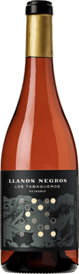 En glasflaska med Llanos Negros Los Tabaqueros, ett vitt vin från Spanien